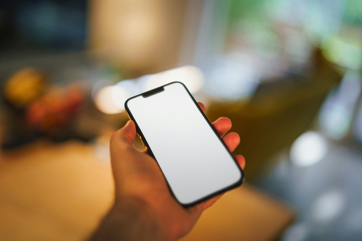 A hand holding a phone